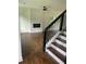 Modern staircase with dark wood treads and black metal railing at 4604 Shumart Dr, Snellville, GA 30039