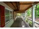 Wooden porch with red shutters and wooded backyard view at 146 Mount Bethel Rd, Mcdonough, GA 30252
