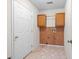 Bright laundry room with wood cabinets and hexagon tile floor at 2361 Georgia Ln, Snellville, GA 30078