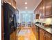 Galley kitchen with wood cabinets, granite counters, and black appliances at 1735 Peachtree Ne St # 210, Atlanta, GA 30309