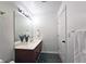 Clean bathroom with dark wood vanity, updated lighting, and a large mirror at 1735 Peachtree Ne St # 210, Atlanta, GA 30309