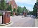 Gated community entrance with brick pillars and wrought iron gate at 1735 Peachtree Ne St # 210, Atlanta, GA 30309