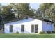 Rear view of modern single story home with white brick exterior, dark trim, and landscaped yard at 18 Cheney St, East Point, GA 30344