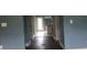 Long hallway with worn flooring and damaged walls leading to the kitchen at 2159 Martin Luther King, Jr. Dr, Atlanta, GA 30310