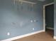Bedroom with blue walls, brown carpet, and a shelf at 2159 Martin Luther King, Jr. Dr, Atlanta, GA 30310