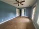 Large bedroom featuring carpet, ceiling fan, and multiple doors at 2159 Martin Luther King, Jr. Dr, Atlanta, GA 30310