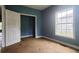 Bedroom with blue walls, white door, and window at 2159 Martin Luther King, Jr. Dr, Atlanta, GA 30310