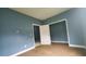 Empty bedroom with blue walls and white doors at 2159 Martin Luther King, Jr. Dr, Atlanta, GA 30310