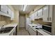 Efficient kitchen with white cabinets, appliances, and double sink at 3010 Parc Lorraine, Lithonia, GA 30038