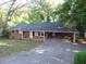 Brick ranch house with carport and mature trees at 1142 Hembree Ln, Austell, GA 30168