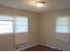 Bright bedroom with two windows and wood flooring at 1142 Hembree Ln, Austell, GA 30168