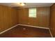 Basement bedroom with wood paneled walls and LVP flooring at 1142 Hembree Ln, Austell, GA 30168