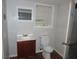Basement powder room with toilet and sink vanity at 1142 Hembree Ln, Austell, GA 30168