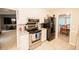 Well-equipped kitchen with stainless steel appliances and view to living room at 377 Mill Ridge Way, Lawrenceville, GA 30046