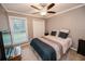 Cozy bedroom with queen bed and ceiling fan at 377 Mill Ridge Way, Lawrenceville, GA 30046