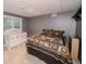 Basement bedroom with crib and queen-size bed at 377 Mill Ridge Way, Lawrenceville, GA 30046
