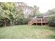 Large backyard with deck, trees, and playset at 377 Mill Ridge Way, Lawrenceville, GA 30046