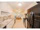 Modern kitchen with white cabinets, stainless steel appliances and breakfast nook at 377 Mill Ridge Way, Lawrenceville, GA 30046
