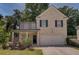 Two-story brick home with a front porch and driveway at 2248 Annes Lake Cir, Lithonia, GA 30058