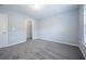 Bedroom with gray carpet, window, and walk-in closet at 2100 Meadow Peak Rd, Duluth, GA 30097