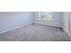 Spacious bedroom with gray carpet and large window at 2100 Meadow Peak Rd, Duluth, GA 30097