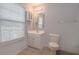 Bathroom with white vanity, toilet, and shower/tub combo at 2100 Meadow Peak Rd, Duluth, GA 30097