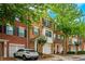 Brick townhouses with attached garages and lush landscaping at 2100 Meadow Peak Rd, Duluth, GA 30097