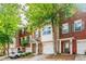 Brick townhouse with two-car garage and landscaping at 2100 Meadow Peak Rd, Duluth, GA 30097