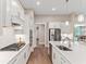 Modern kitchen boasts white cabinets, stainless steel appliances, and a large island at 105 Summerlin Dr, Canton, GA 30115