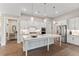 Modern kitchen with white cabinets, large island, and stainless steel appliances at 105 Summerlin Dr, Canton, GA 30115