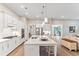 Open concept kitchen featuring white cabinetry, a sizable island, and high-end appliances at 105 Summerlin Dr, Canton, GA 30115