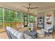Spacious screened porch with comfortable seating and a ceiling fan at 105 Summerlin Dr, Canton, GA 30115