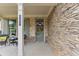 Inviting front porch with stone facade and seating area at 105 Summerlin Dr, Canton, GA 30115
