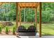 Covered patio with swing and view of yard at 105 Summerlin Dr, Canton, GA 30115
