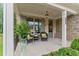 Relaxing front porch with wicker chairs and lush greenery at 105 Summerlin Dr, Canton, GA 30115