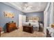 Main bedroom with gray walls, ceiling fan, and a rustic wooden headboard at 104 Streambank Ct, Temple, GA 30179