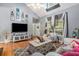 Living room with vaulted ceilings, hardwood floors, and large windows at 104 Streambank Ct, Temple, GA 30179