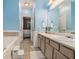 Double vanity bathroom with light blue walls and a view of another bedroom at 104 Streambank Ct, Temple, GA 30179