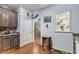 Kitchen offers ample counter space, dark wood cabinets, and a view into the living room at 104 Streambank Ct, Temple, GA 30179