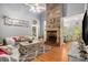 Living room features a stone fireplace and hardwood floors at 104 Streambank Ct, Temple, GA 30179