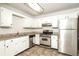 Kitchen with stainless steel appliances and white cabinets at 4245 Brandy Ann Dr, Acworth, GA 30101