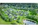 Aerial view of a community featuring several houses, landscaping, and a pond at 24 Cheney St, East Point, GA 30344