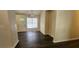 Simple dining area with dark hardwood floors and a view of the front door at 7869 Varden Ct, Douglasville, GA 30134