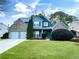 Two-story house featuring brick and blue siding, a two-car garage, and a well-manicured lawn at 923 Buckhorn Bnd, Locust Grove, GA 30248