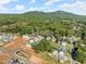 Aerial view of homes nestled in a wooded community near mountains at 217 Wakehurst Way, Marietta, GA 30064