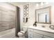 Clean bathroom with a shower/tub combo, white vanity, and gray tile at 3351 Orwell Way # 2104, Cumming, GA 30041