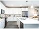 Modern white kitchen with island, stainless steel appliances, and hardwood floors at 3351 Orwell Way # 2104, Cumming, GA 30041