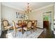 Formal dining room with chandelier and hardwood floors at 714 Beacon Cv, Lawrenceville, GA 30043