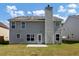 Two story house with grey siding, backyard, and patio at 5908 Bluegrass Vw, Fairburn, GA 30213