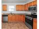 Modern kitchen featuring wood cabinets and stainless steel appliances at 5908 Bluegrass Vw, Fairburn, GA 30213